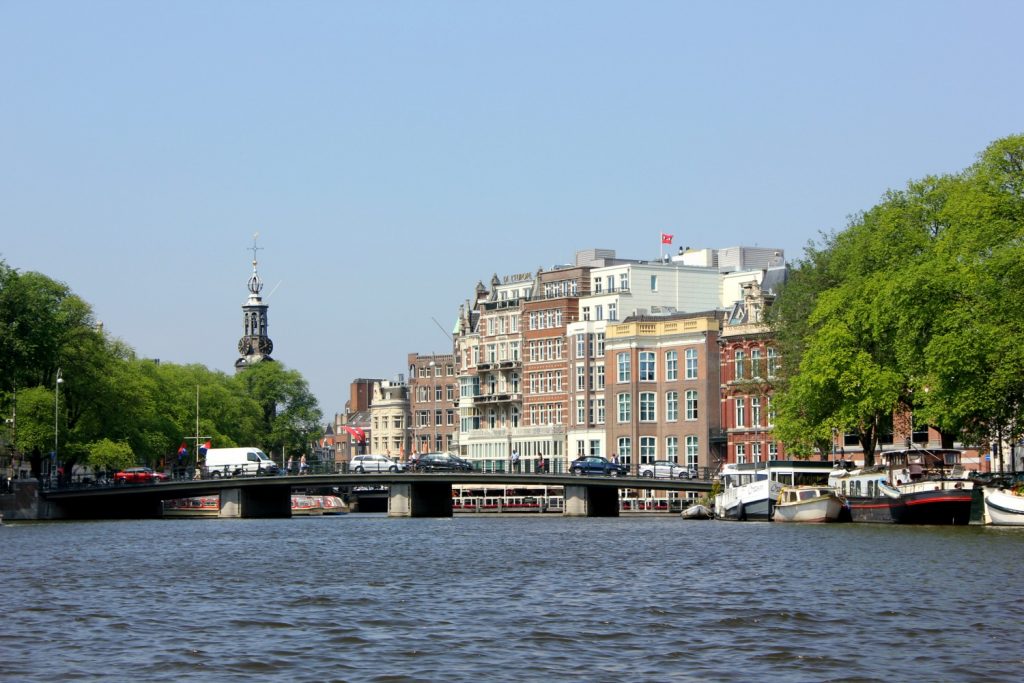 View along the canal in Amsterdam to a bridge and the Westerkirk