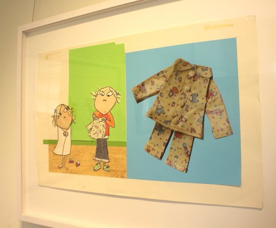 Illustration of Charlie and Lola from the Charlie and Lola books in the Lauren Child exhibition at Mottisfont Hampshire alongside a photo of the the pyjamas which inspired the drawing