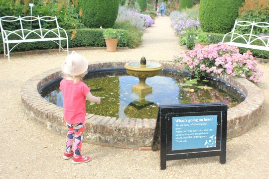 My daughter by a small fountain at Mottisfont in Hampshire