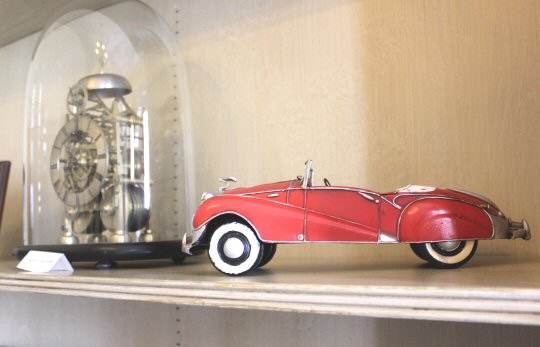 Old toy car on one of the shelves at Mottisfont