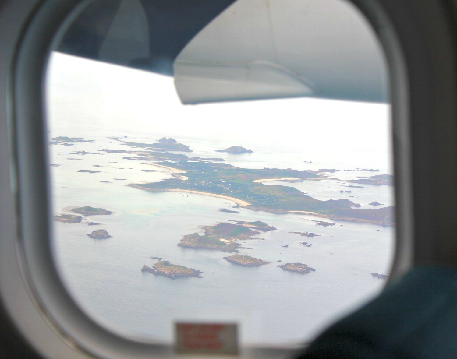 Aerial view through the plane window of the Isles of Scilly - my reasons to visit the Isles of Scilly
