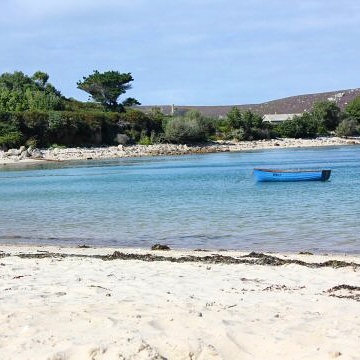 Boat in a bay off the beach in Bryher in the Isles of Scilly