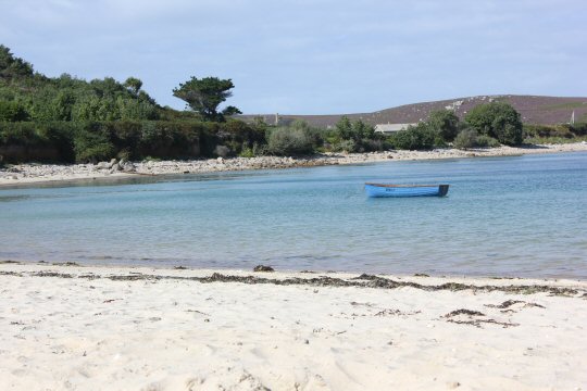 A boat on the calm waters off Bryher - my reasons to visit the Isles of Scilly