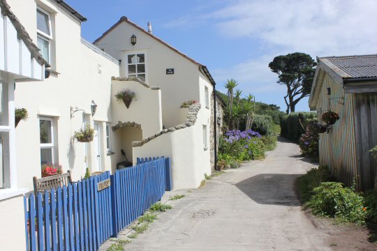 White houses along the street in St Martins - my reasons to visit the Isles of Scilly