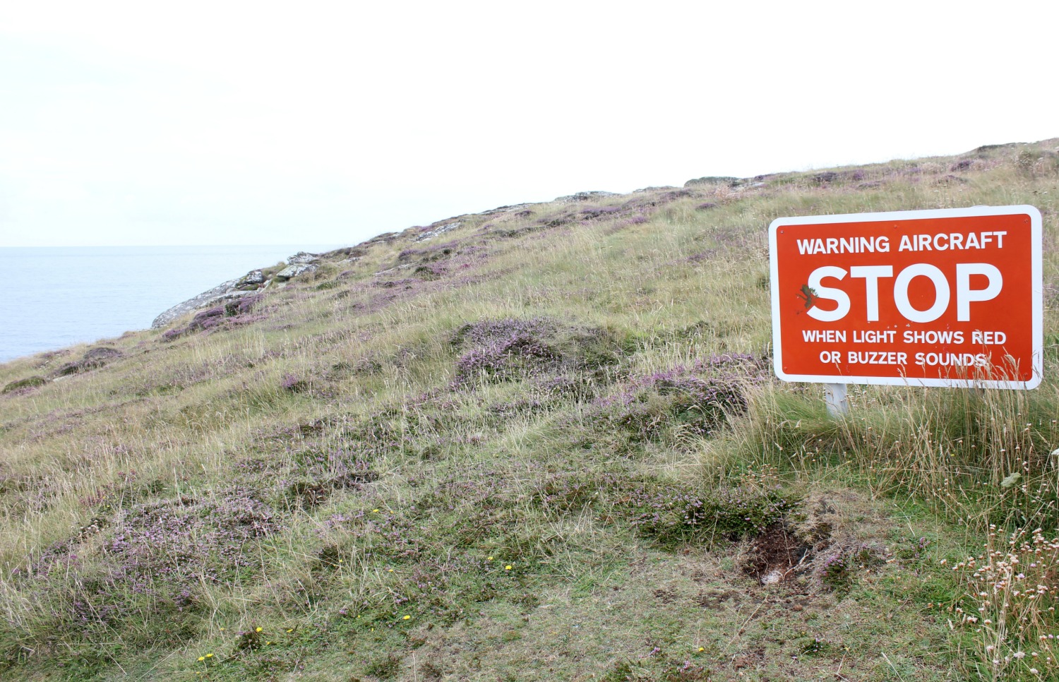 Sign warning of the airport on St Mary's, visible from the cliff path around the island in the Isles of Scilly