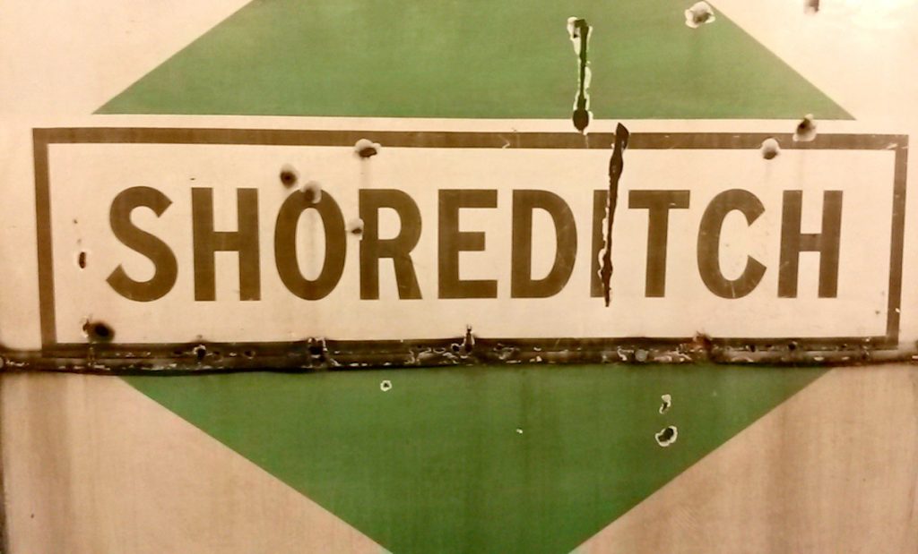 Vintage green and white tube sign for Shoreditch - exploring the London Transport Museum depot with kids
