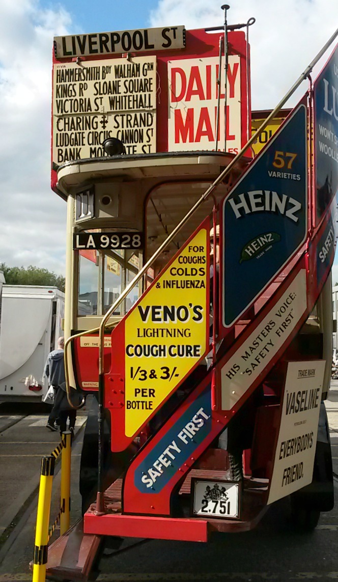 Vintage tram outside the Acton depot with old adverts all over it - exploring the London Transport Museum depot with kids
