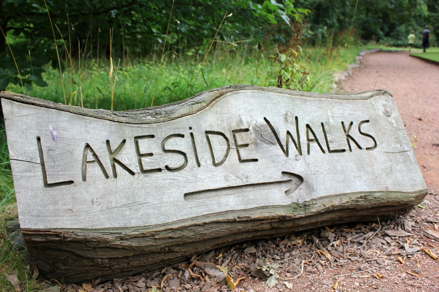 Carved wooden log sign showing the way to the lakeside walk at Nostell Priory, during our weekend in Yorkshire