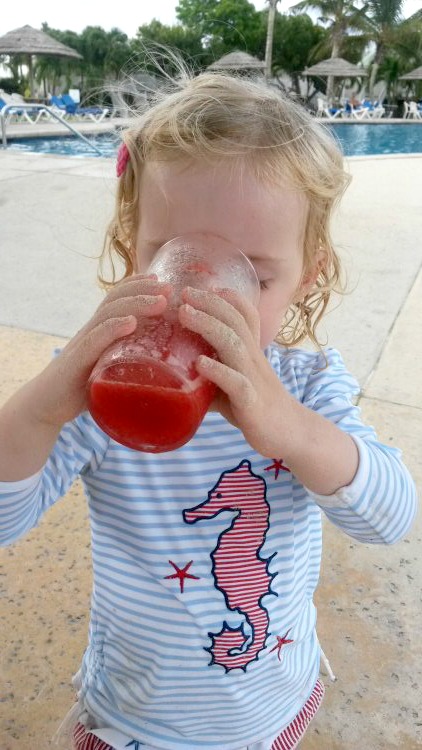 My daughter drinking a frozen strawberry drink at Verandah Resort in Antigua