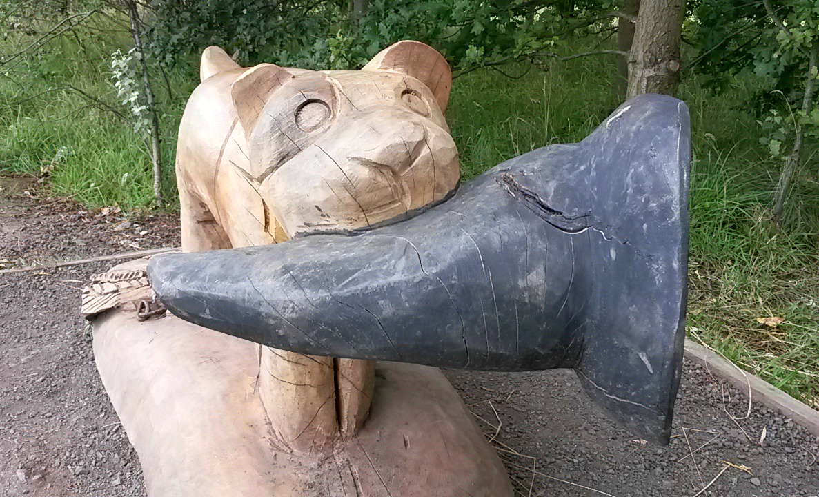 Carved dog statue with witch's hat in its mouth on the Room on the Broom trail, Wakefield
