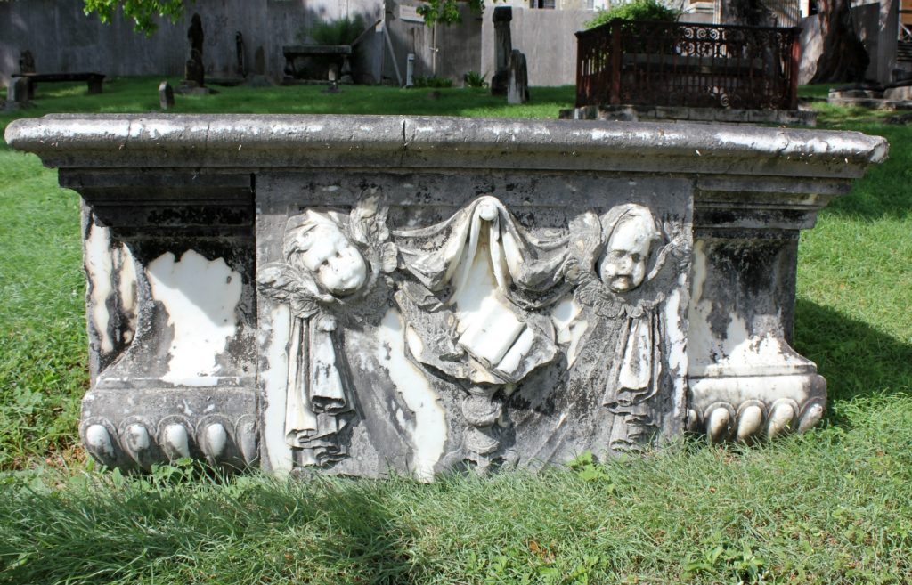 An elaborate tomb with claw feet in the graveyard of St John's cathedral in Antigua