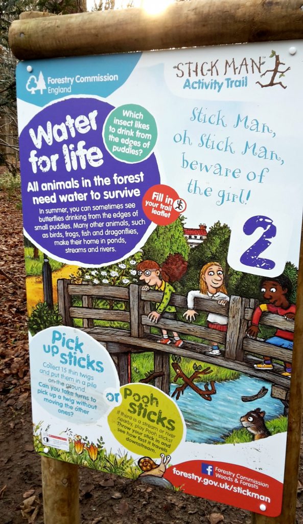 My daughter looks at one of the signs about water on the Stick Man trail on a family day out in Buckinghamshire, at Wendover Woods