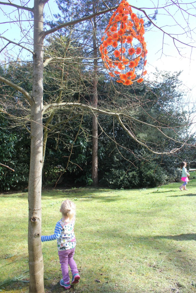 My daughter spotting an egg clue by a tree at Cliveden National trust on the Easter Egg hunt