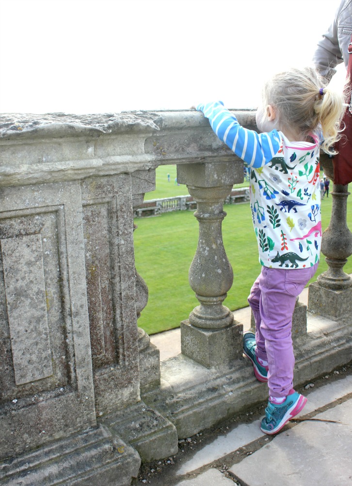 My daughter climbing on the stone balustrade above the parterre at Cliveden National Trust