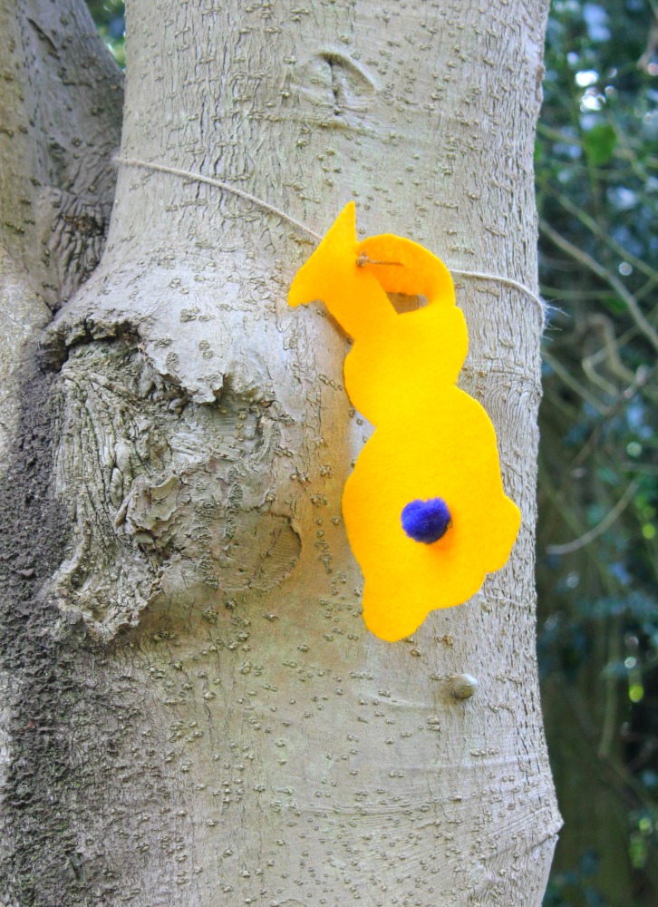 Yellow rabbit clue in a tree at the Cliveden Easter Egg hunt