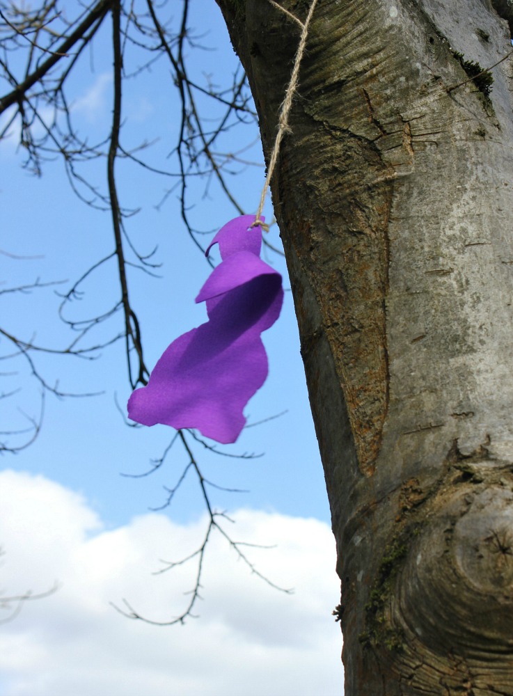 Purple rabbit clue in a tree against a blue sky at the Cliveden Easter Egg hunt