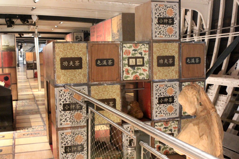 Decorative tea crates with Chinese characters on in the hold of the Cutty Sark - visiting Greenwich with kids