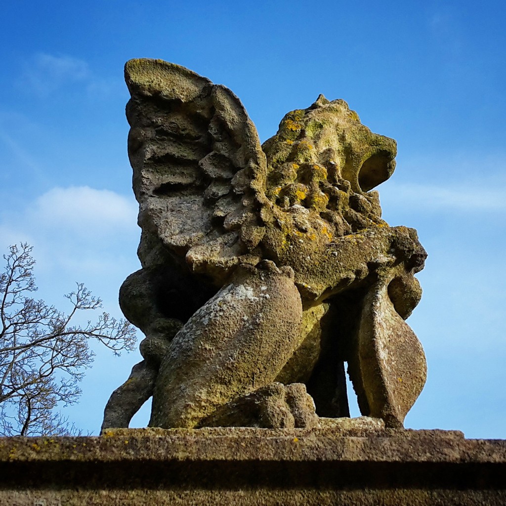 Stone lion statue in the grounds at Polesden Lacey on a family day out