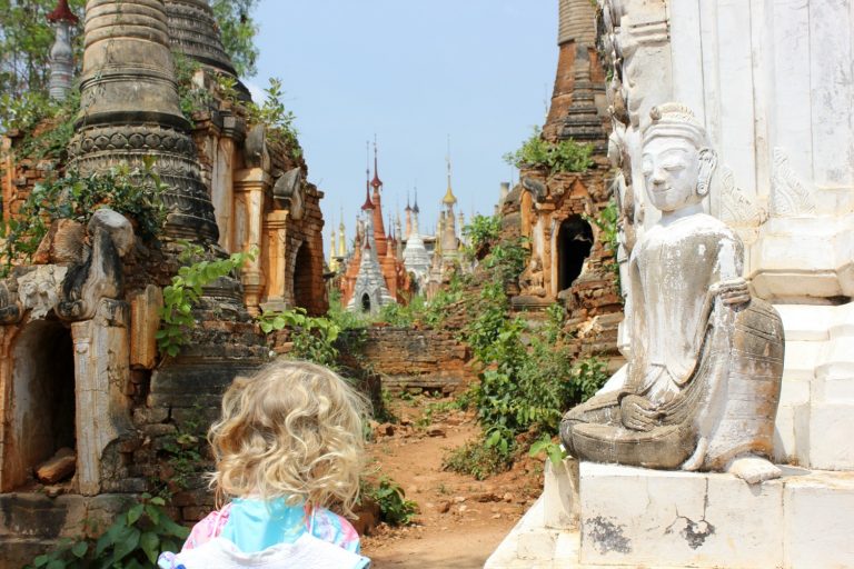My three-year-old girl eyeing up the stupas and temple at In Dein on Inle Lake, Burma (Myanmar) - one of my top things to do at Inle Lake with kids