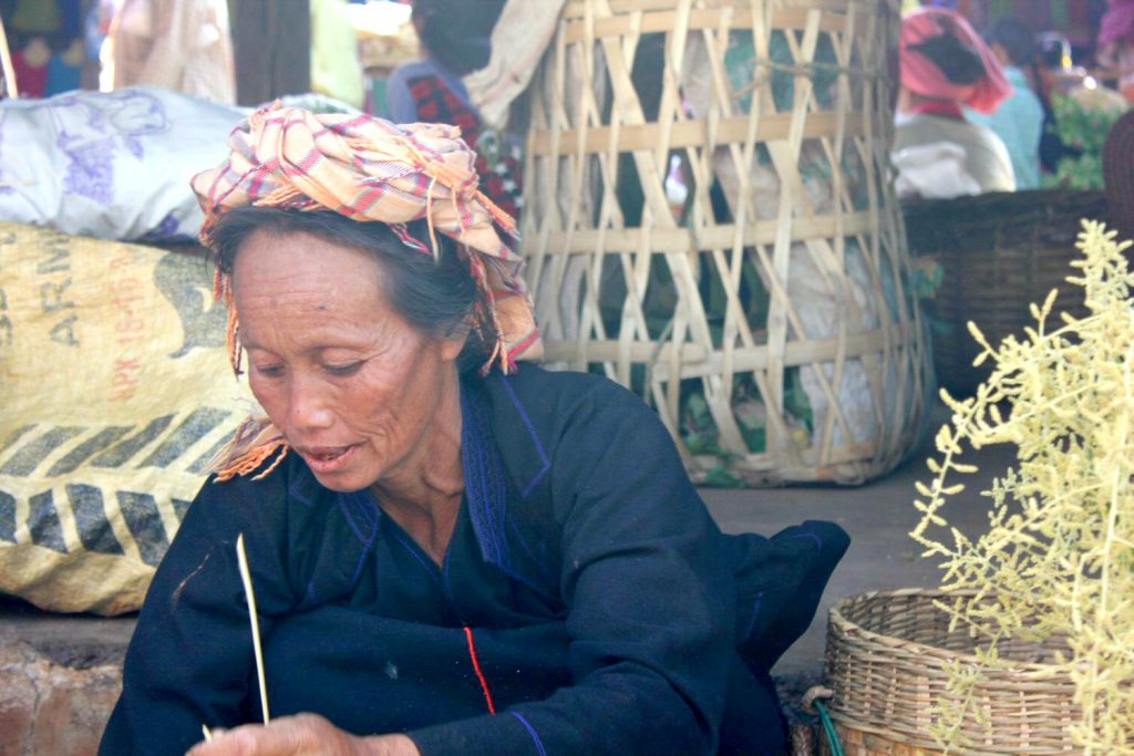 Woman at a market near Inle Lake in Burma. With Burma newly opened up to tourists, and off the beaten track for most families, here are my 12 reasons to visit Burma (Myanmar) - in photos