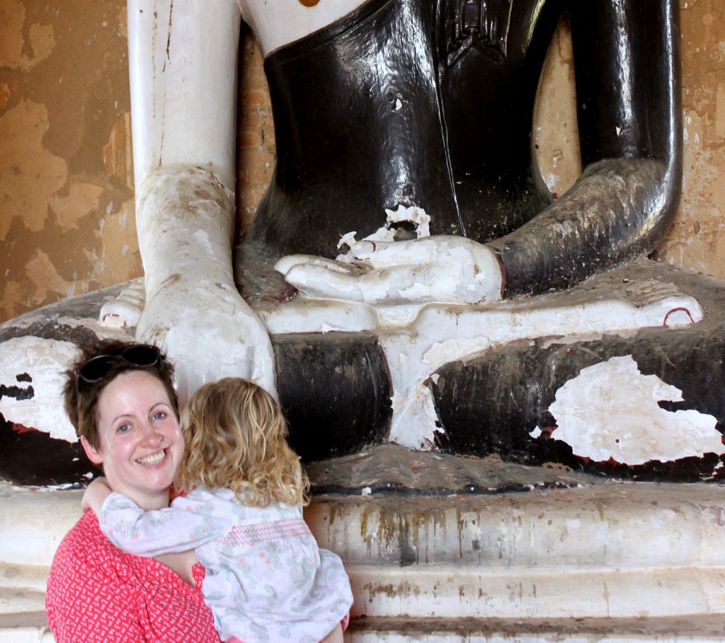 Girl hiding her face from the camera in a temple in Bagan, Burma (Myanmar)