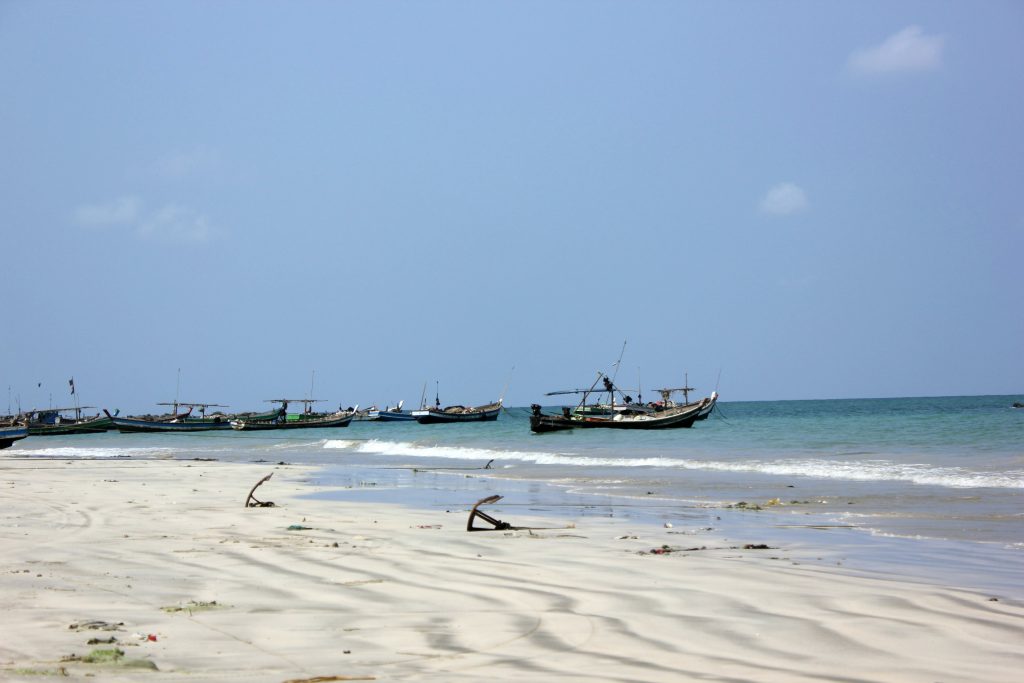 View of boats and anchors on the white sand by the Indian Ocean at Ngapali beach - discovering another side to Burma beach holidays