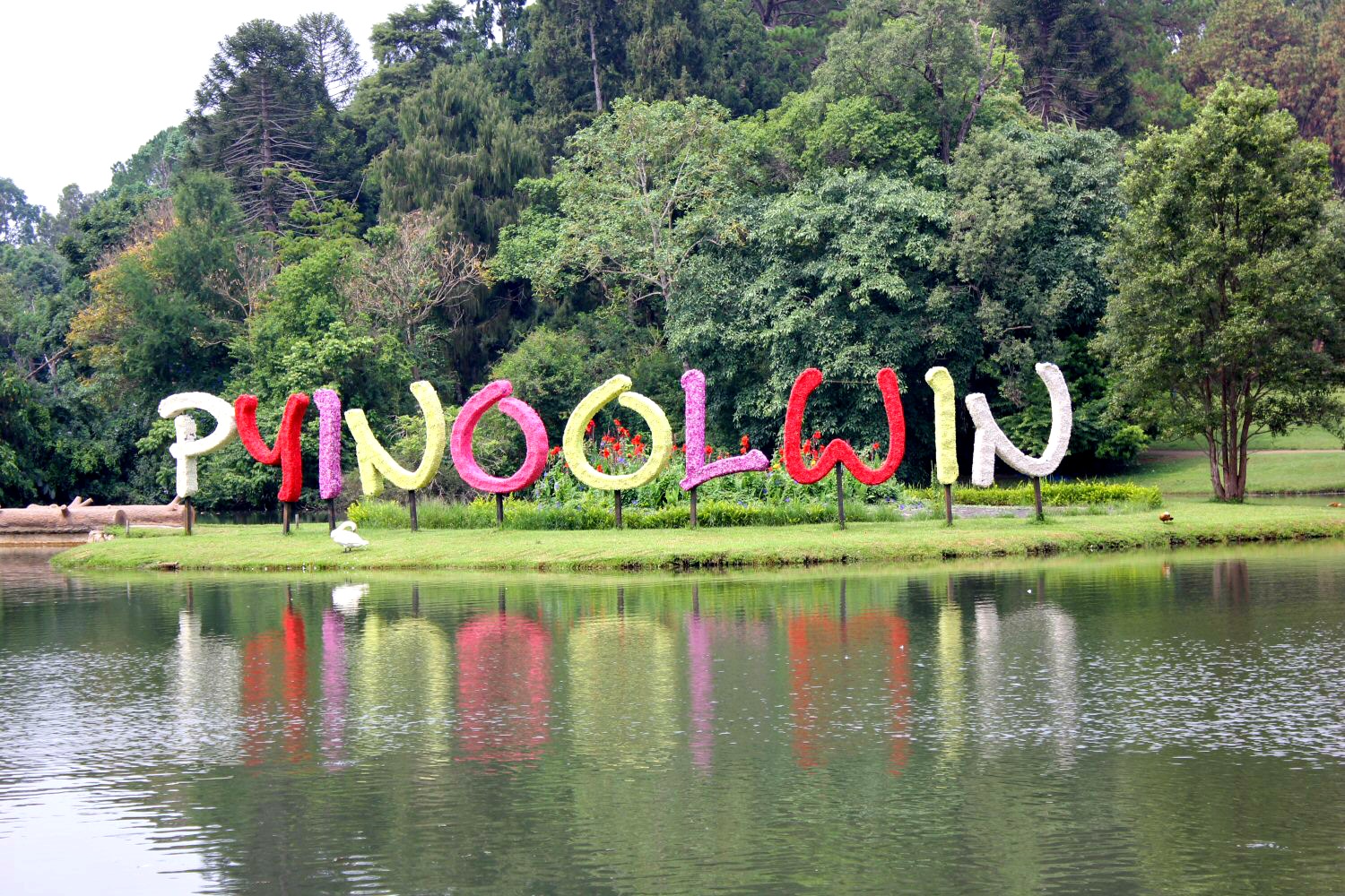 The words Pyin Oo Lwin in bright colours on a lakeside garden at the Pyin Oo Lwin botanical gardens in Burma (Myanmar)