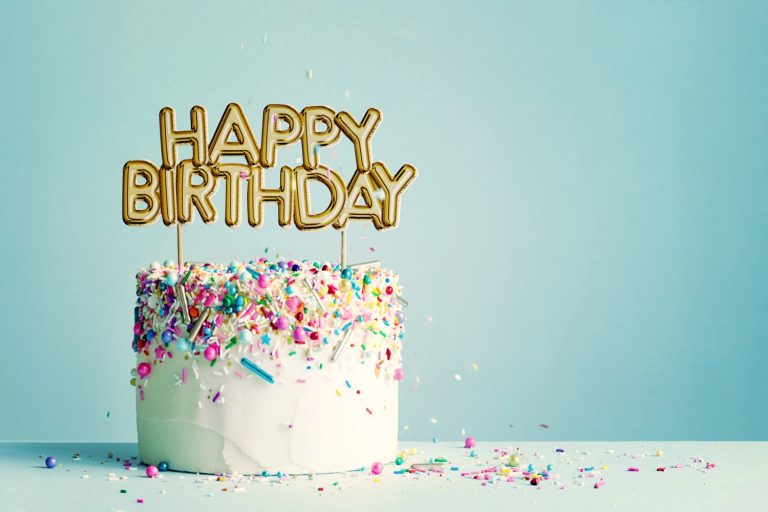 Birthday cake with gold happy birthday banner. Looking back on four years of travels with a child, as my daughter turns four - the end of one era of family travel for us, the start of a new?