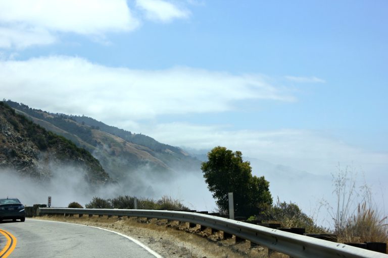 View of Highway 1 with the clouds against the hills. 56 reasons to visit California with a drive along the Pacific Coast Highway - my road trip in photos