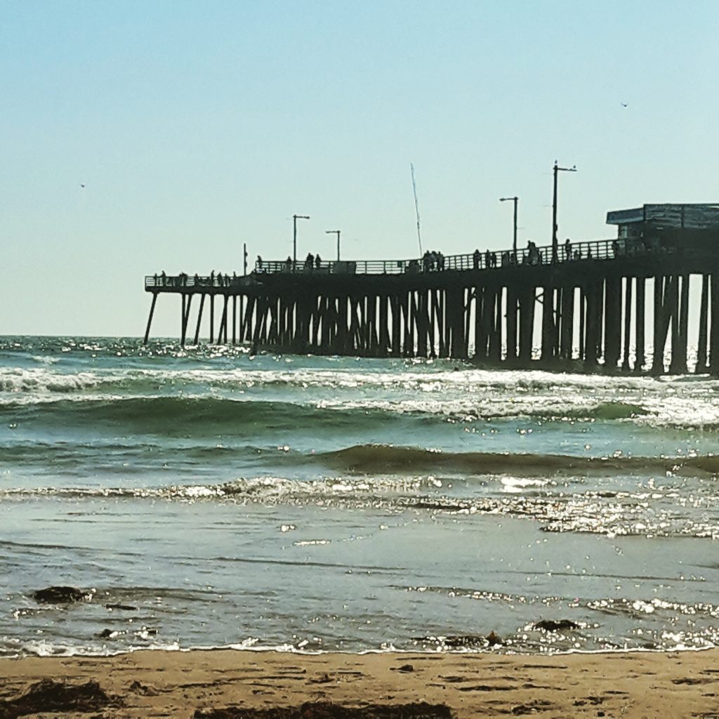 View of the pier above the waves at Pismo Beach - my Pacific Coast Highway pictures and reasons to visit California