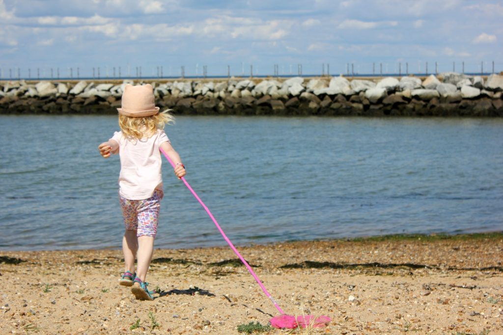 My daughter with a net by the seaside at Herne Bay - one of my favourite family days out in Kent