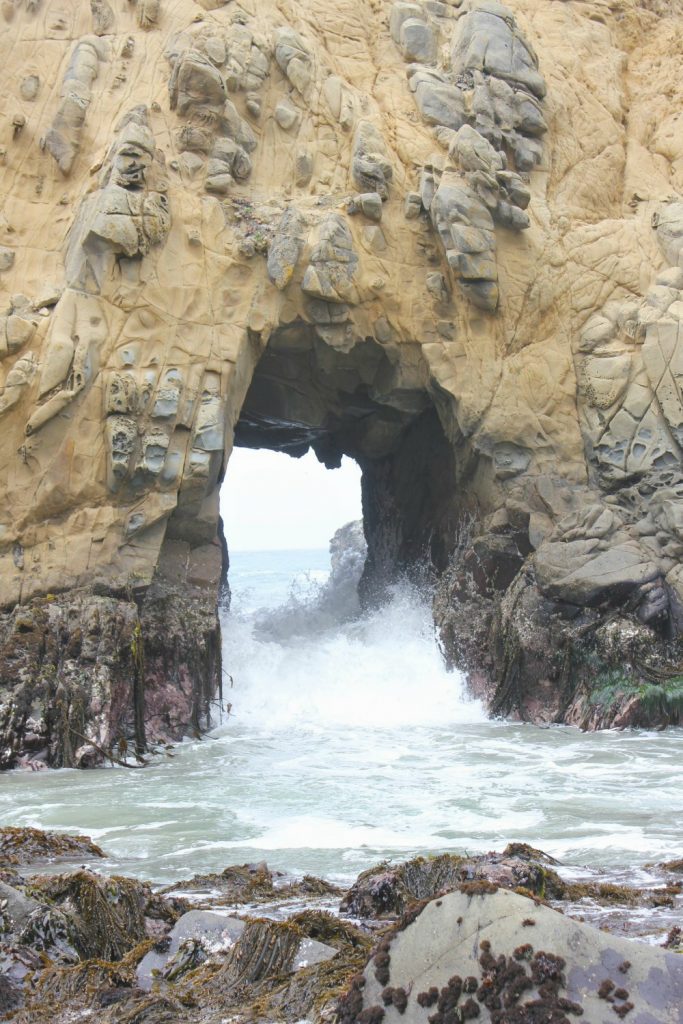 Waves crashing through rock arches at Pfeiffer Beach - my Pacific Coast Highway pictures and reasons to visit California
