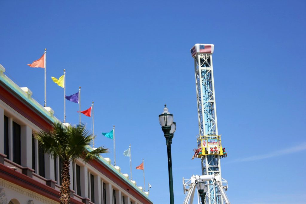Bright flags and rides in the background at the boardwalk in Santa Cruz - my Pacific Coast Highway pictures and reasons to visit California