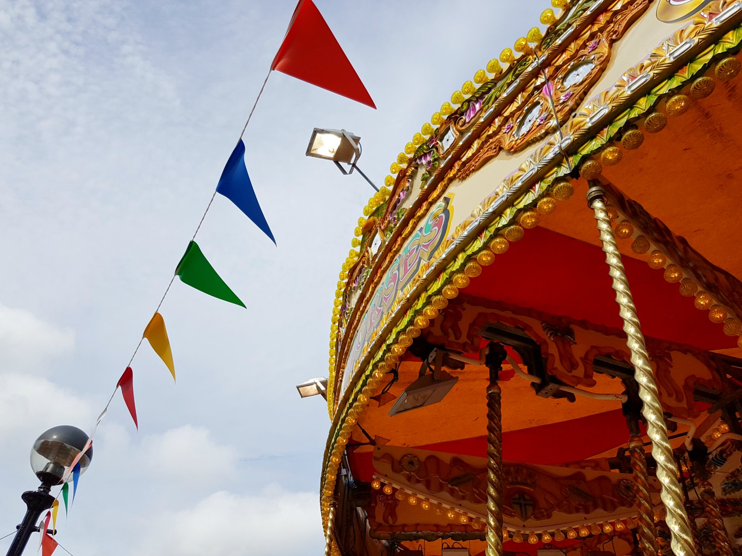 Flags by a carousel in Albert Dock, Liverpool - exploring the Albert Docks kids' attractions. and my Albert Dock review