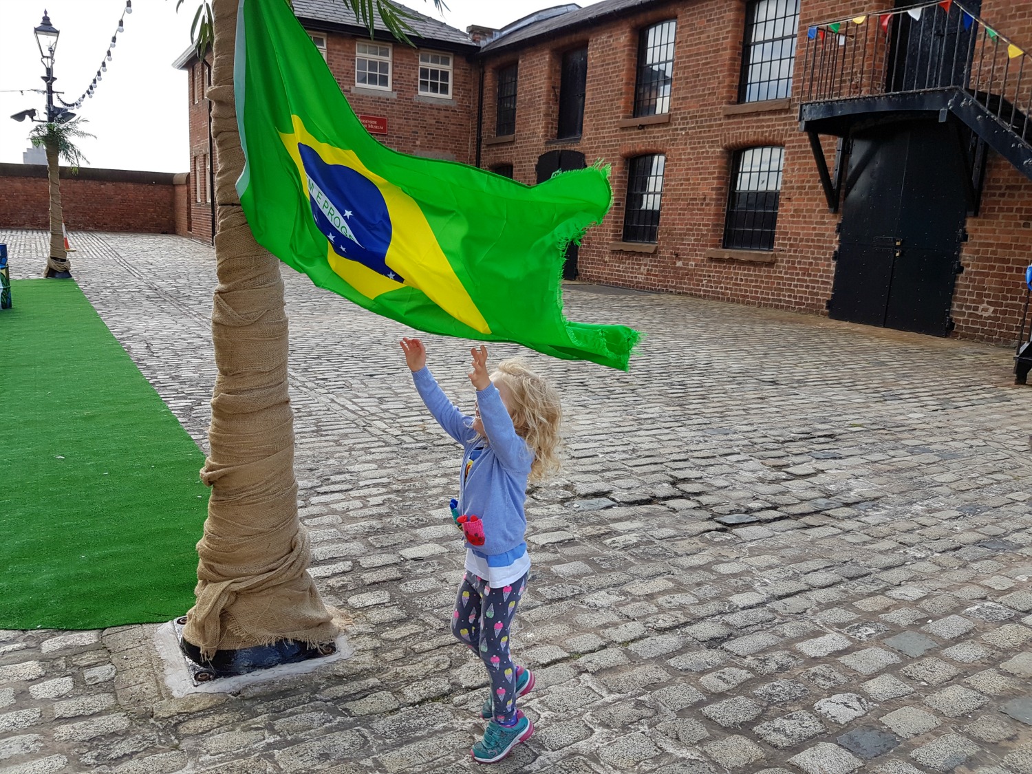 My daughter jumps to catch a Brazilian flat at Albert Dock, Liverpool - exploring the Albert Docks kids' attractions. and my Albert Dock review
