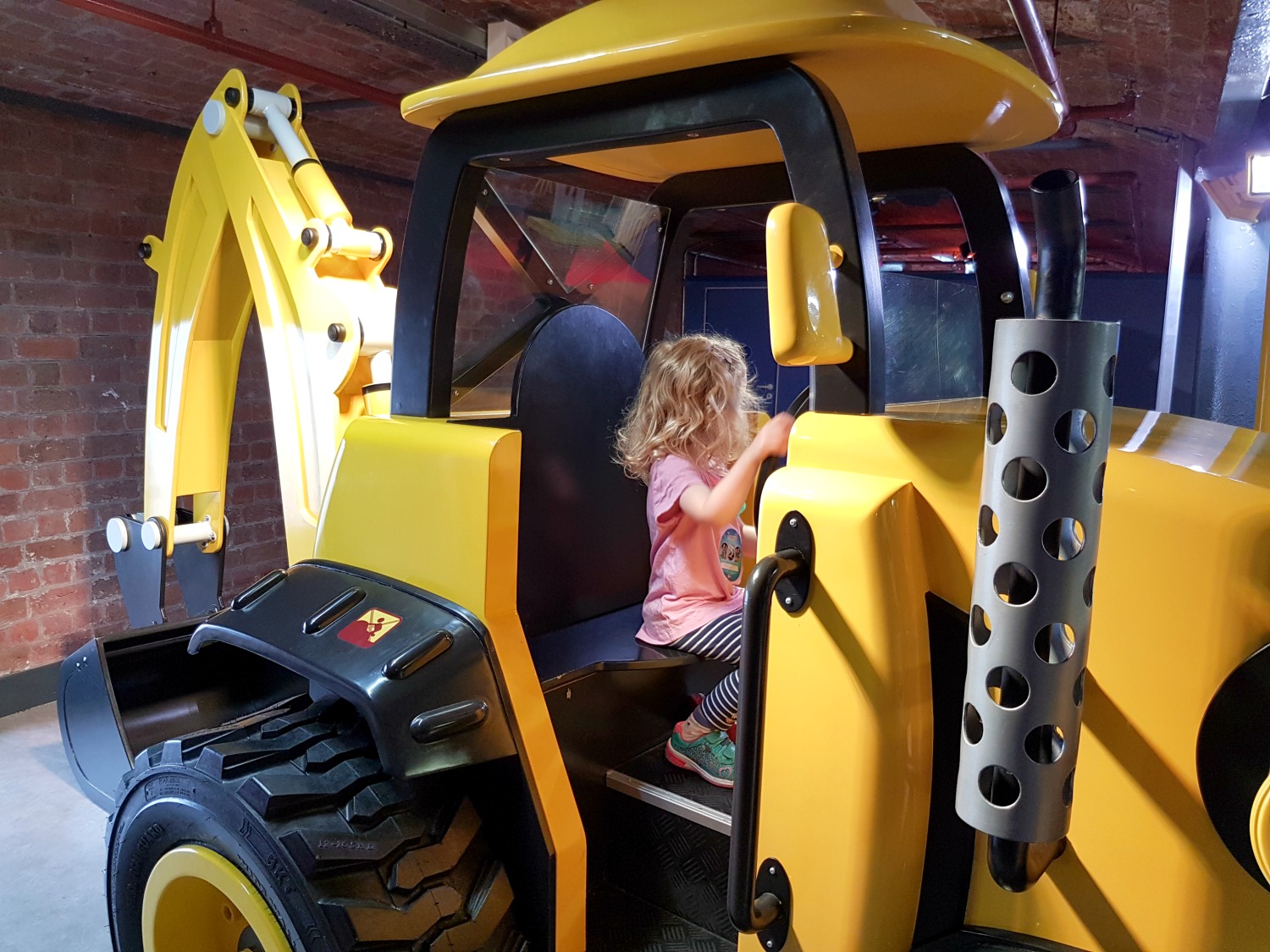 My daughter in a digger in the Bob the Builder section of Mattel Play, one of the main Albert Dock kids attractions