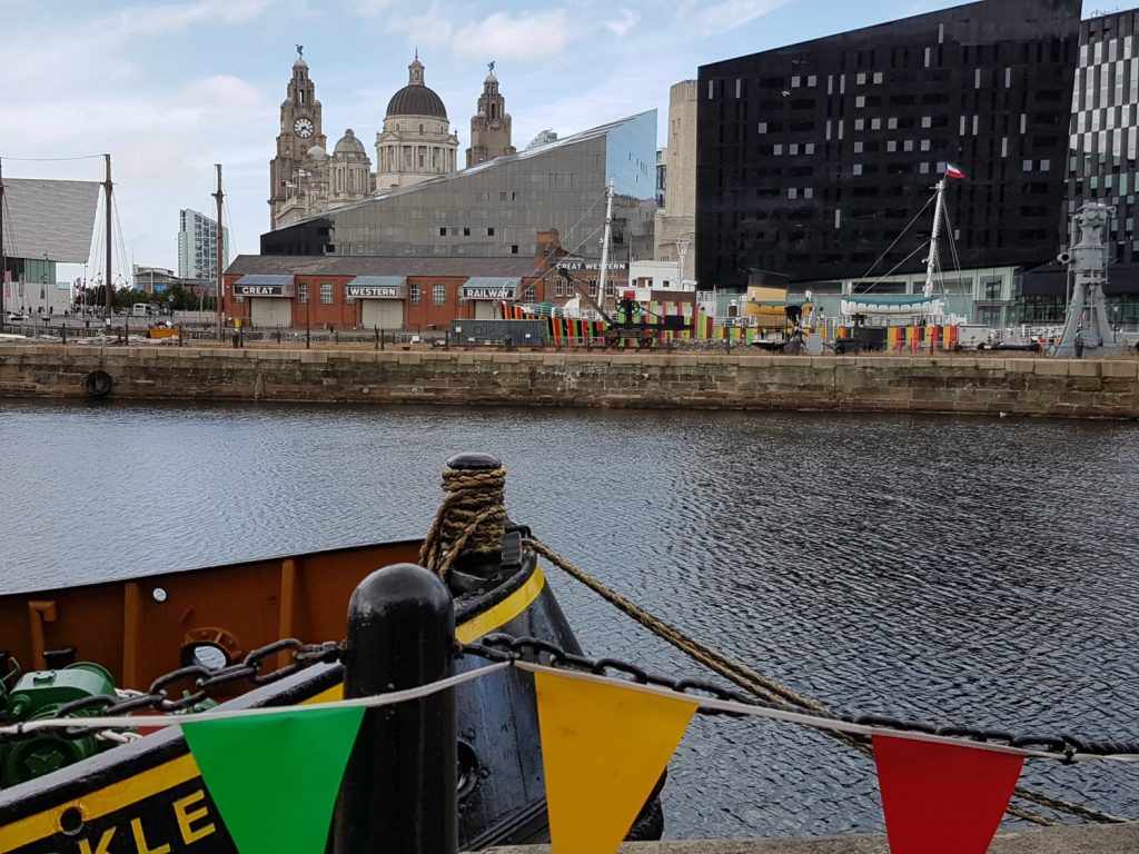 View across the water of Albert Dock to some of the buildings in Liverpool - exploring the Albert Docks kids' attractions.