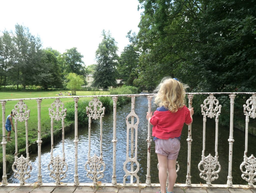 My daughter on the bridge at Morden Hall park, where she saw her first theatre performance at an open air production in the National Trust property rose garden