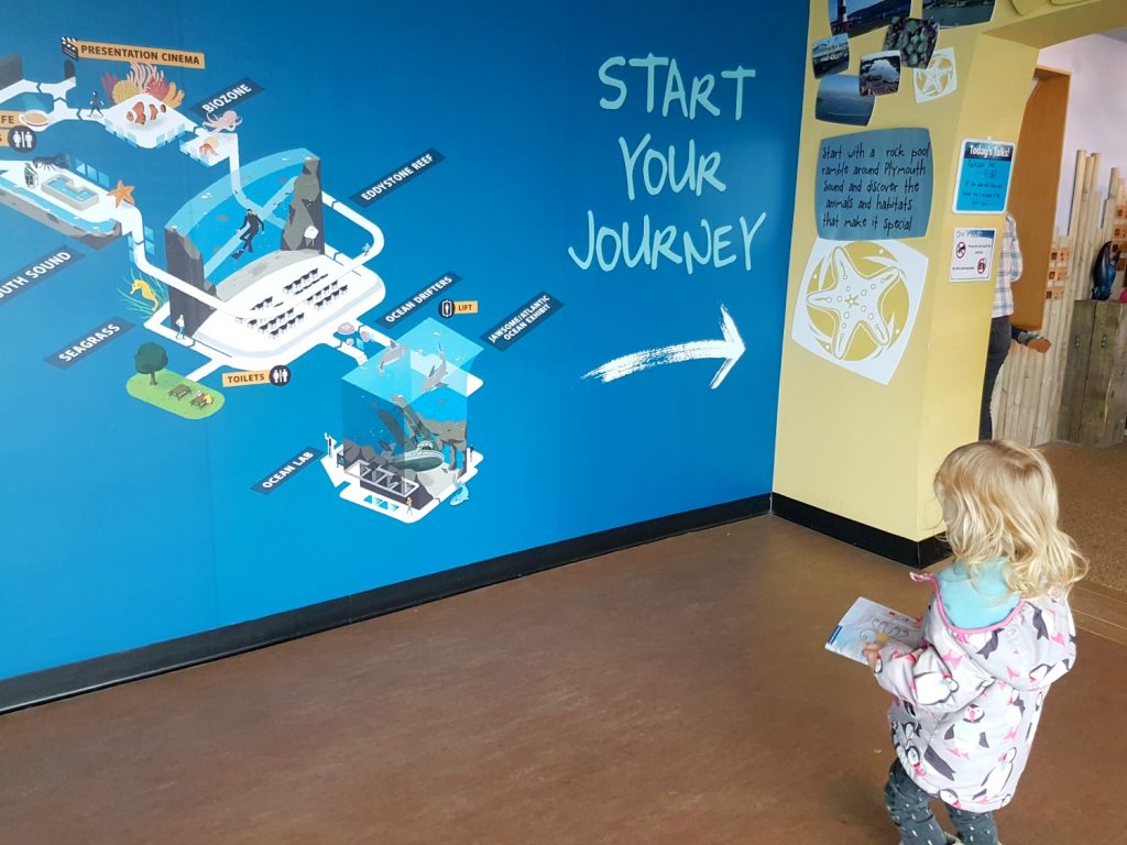 A girl at the entrance to the National Marine Aquarium, , Plymouth - my 13 reasons to visit the Plymouth Aquarium