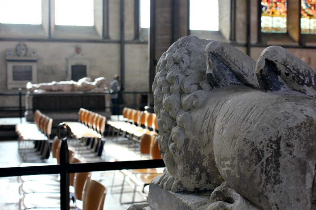 The lion at the feet of one of the medieval effigies, looking out across salisbury cathedral - my visit to Salisbury cathedral with kids