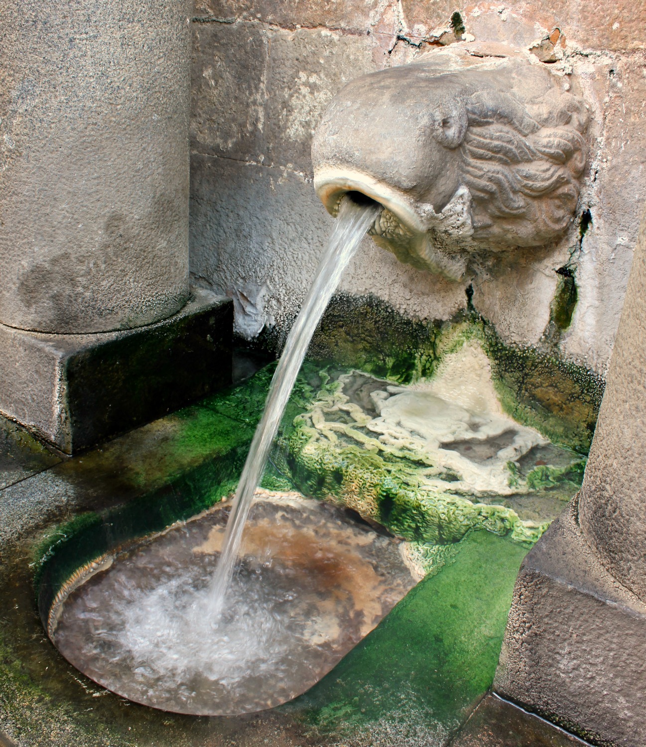 Hot water pours from a fountain in Caldes de Montbui on the Costa Barcelona - one of 13 reasons to visit Costa Barcelona with kids