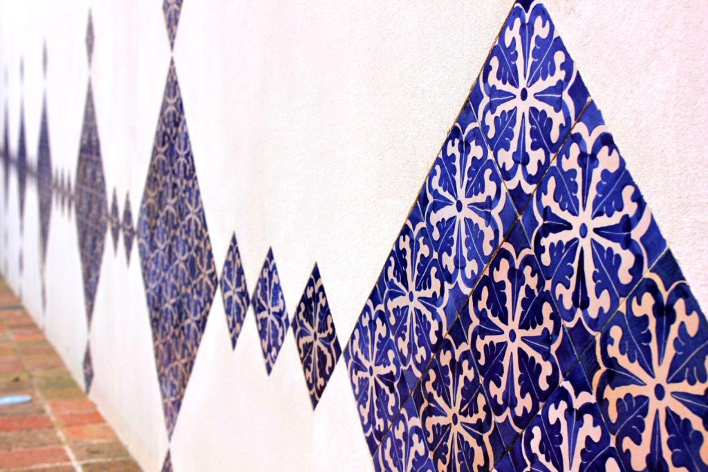 Intricate blue tiles on a white wall at Castelldefels castle. My photo tour of Costa Barcelona