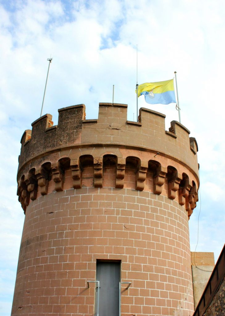 A flag flying above one of the towers at Castelldefels castle. My photo tour of Costa Barcelona
