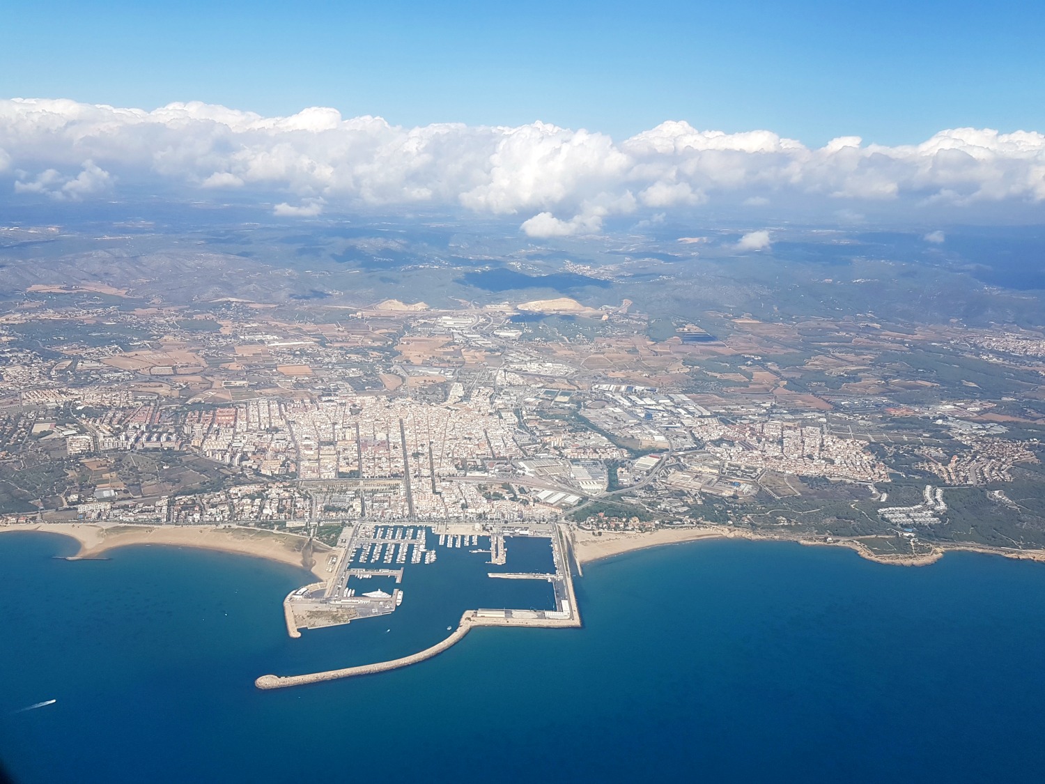 Aerial view down onto Barcelona and the sea - one of 13 reasons to visit Costa Barcelona with kids