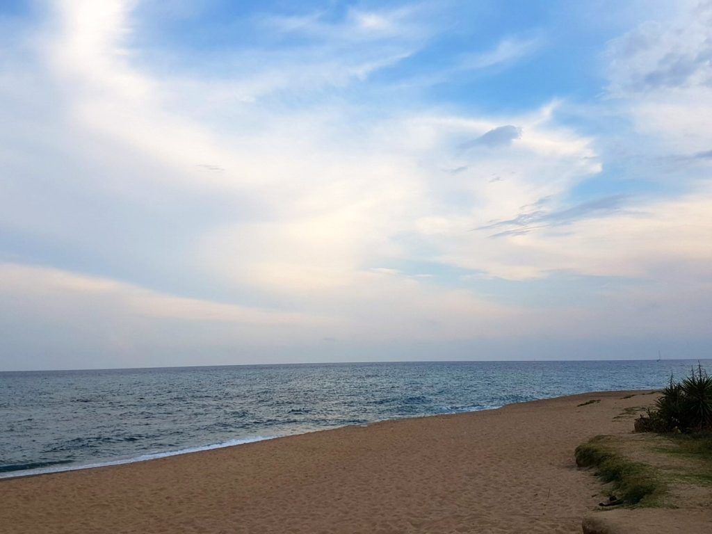 A view of La Tordera beach just before sunset - blue sky over golden sands. My photo tour of Costa Barcelona