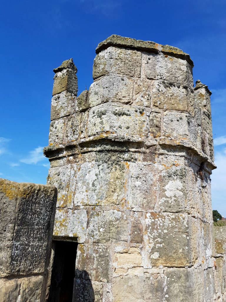 A view of one of the towers at beautiful Bodiam Castle in East Sussex against blue sky - my review and why it's great to visit Bodiam Castle with kids