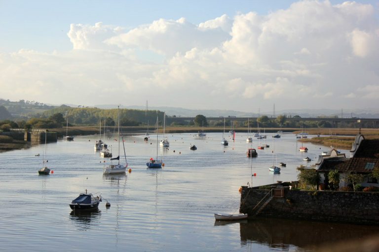 A view out of the boats silhouetted on the estuary at Topsham in Devon - we followed a treasure hunt around the town, a great way to explore Topsham with kids
