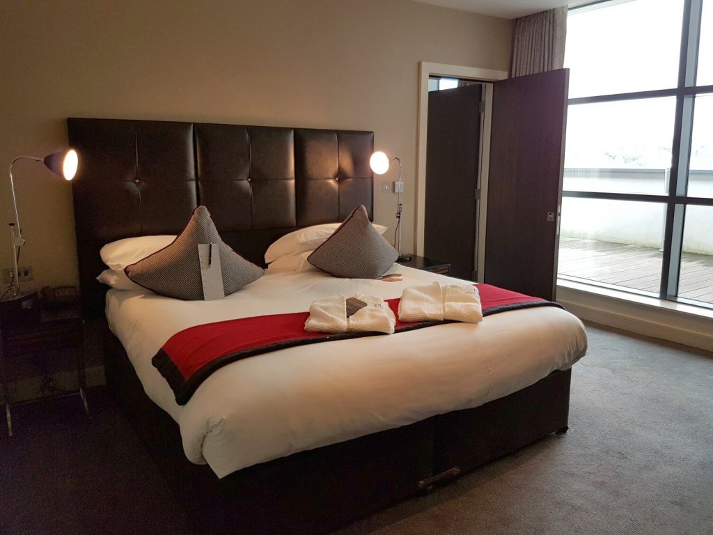 View of the bed with its red and black details in our suite at Brooklands Hotel, Surrey - my review of our stay at Brooklands Hotel with kids