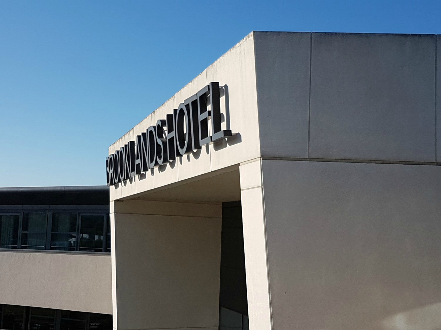 The exterior of Brooklands Hotel, the art deco style building against a blue sky - my review of our stay at Brooklands Hotel with kids