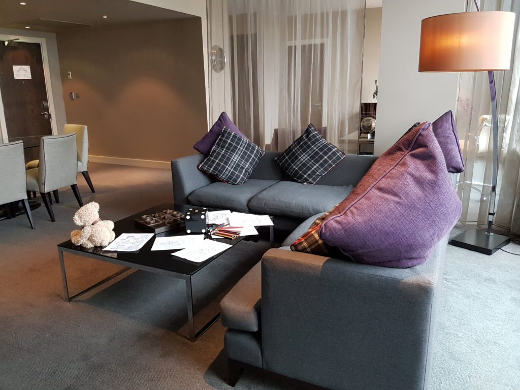 The sofa in the living area with purple cushions at Brooklands Hotel, Surrey - my review of our stay at Brooklands Hotel with kids